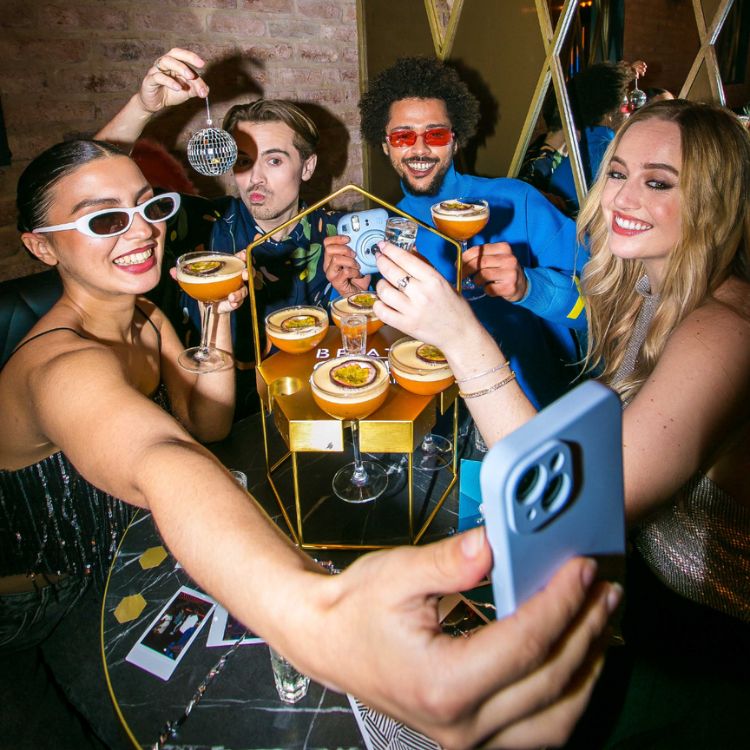 Group of friends sharing cocktails