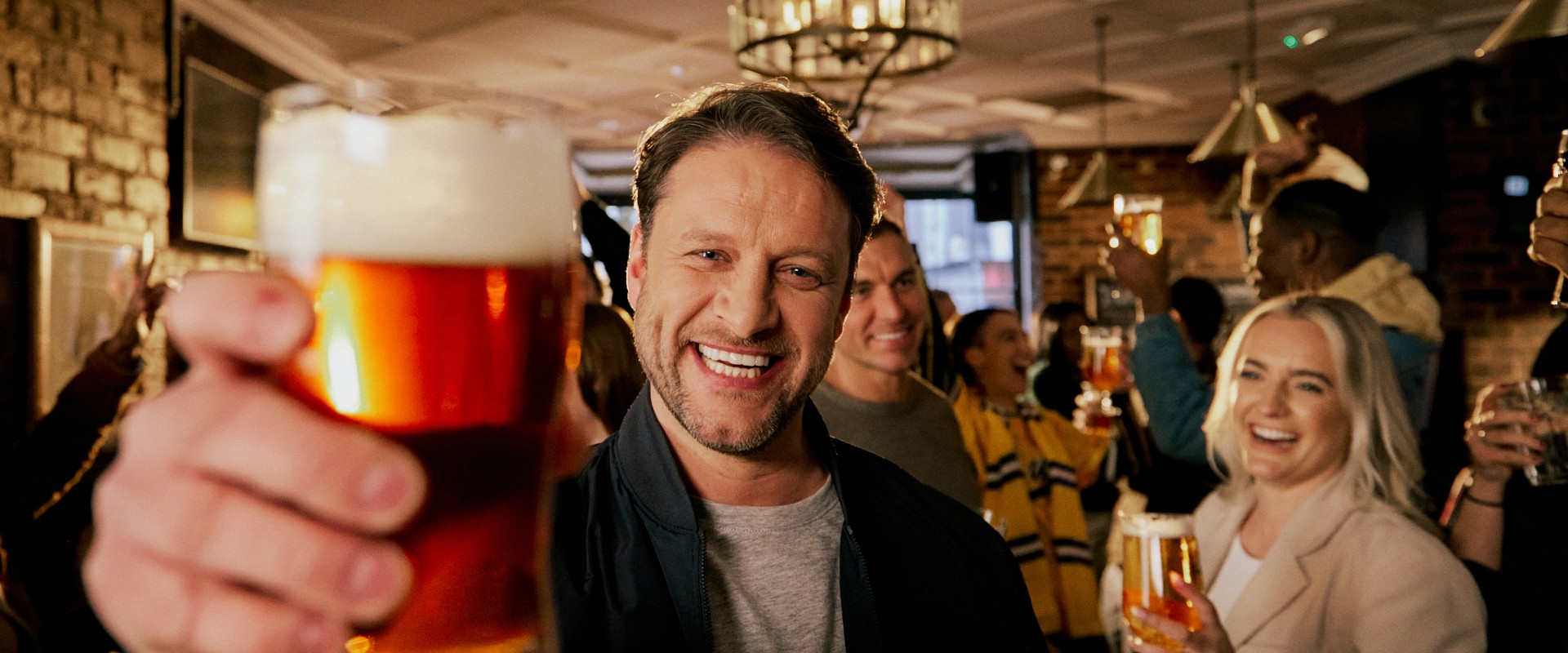 Man smiling in the pub with pint