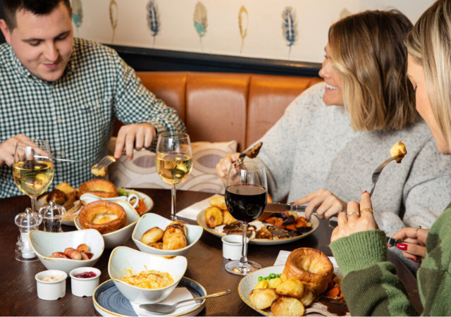 Image of people enjoying a sunday roast in a pub Image of people enjoying a sunday roast in a pub