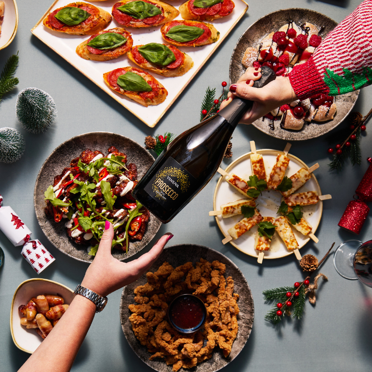 Bottle of prosecco and buffet dishes Bottle of prosecco and buffet dishes